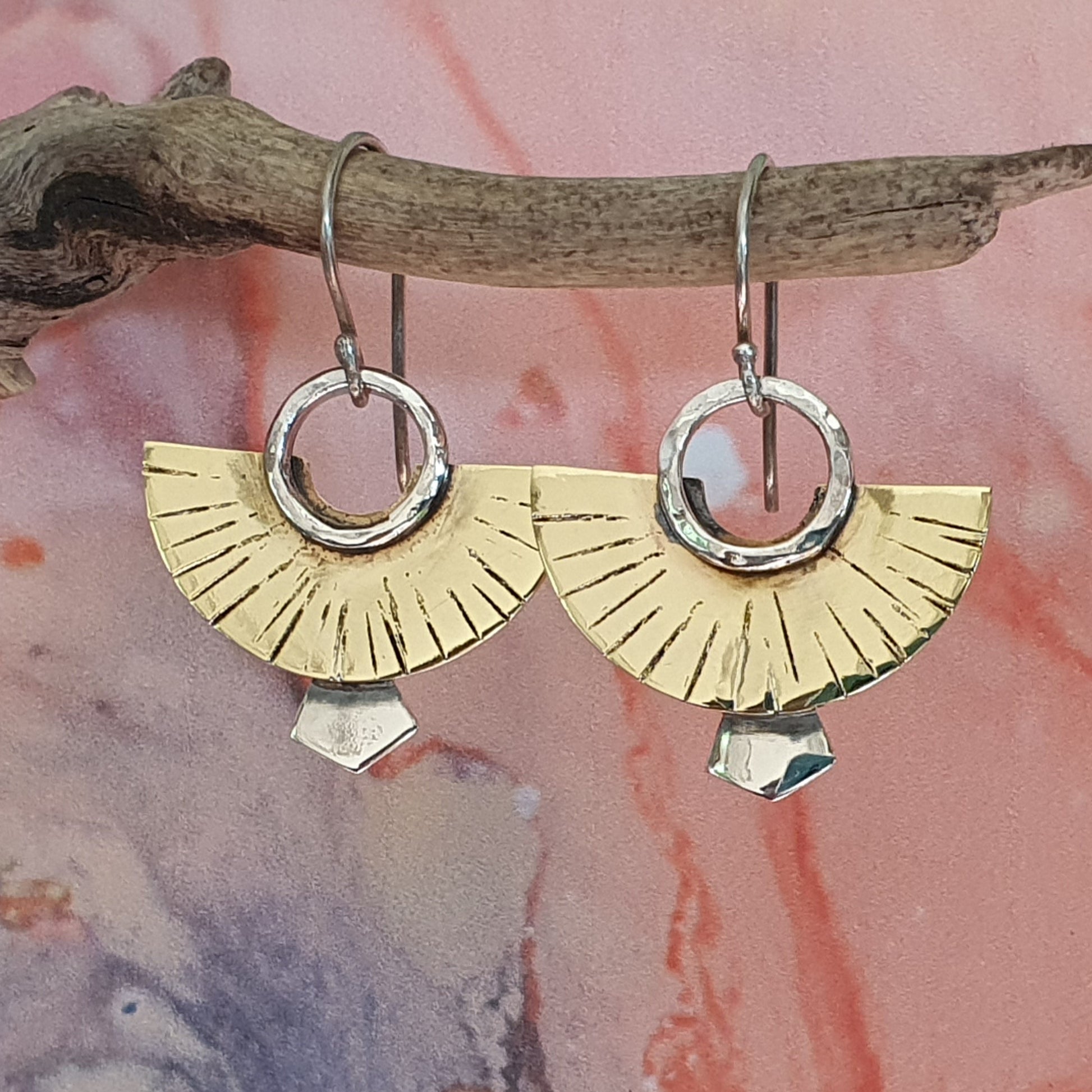 Handcrafted brass and sterling silver Rising Sun earrings with engraved sunburst detail