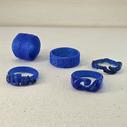 Set of blue plastic rings on a beige fabric background