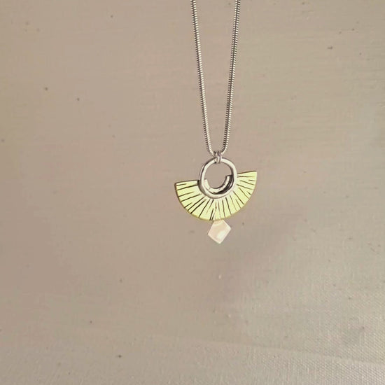 A pendant hanging on a chain